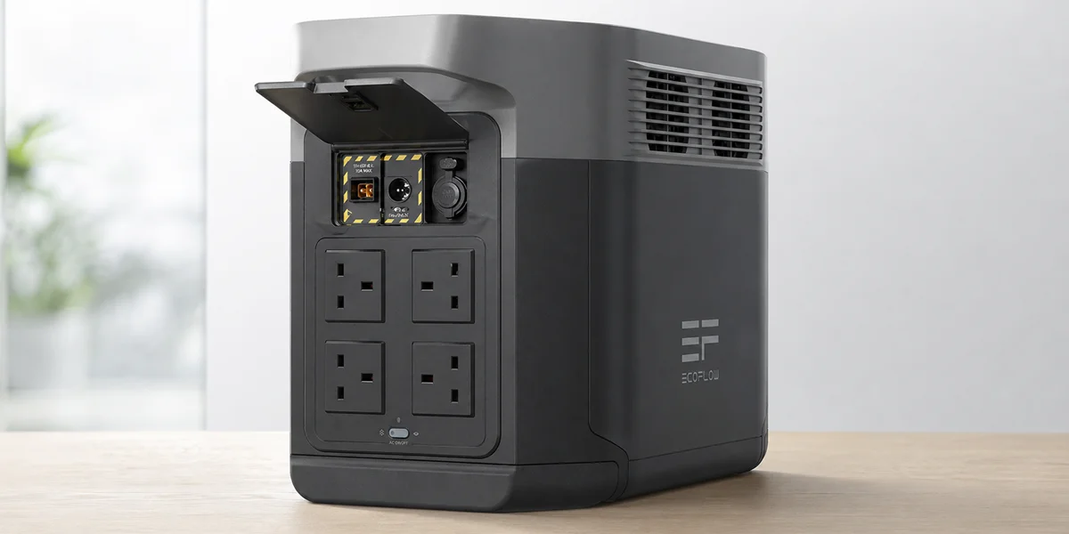 An EcoFlow portable power station showing four AC outlets and input ports on a wooden desk.