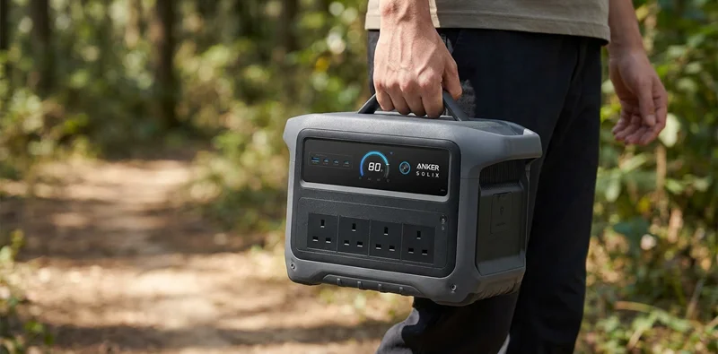 Anker SOLIX C1000 Gen 2 being carried, showing compact size on a trail.