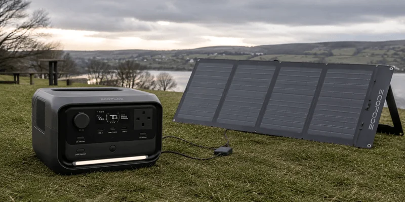 EcoFlow RIVER 3 Plus portable power station charging with a solar panel outdoors
